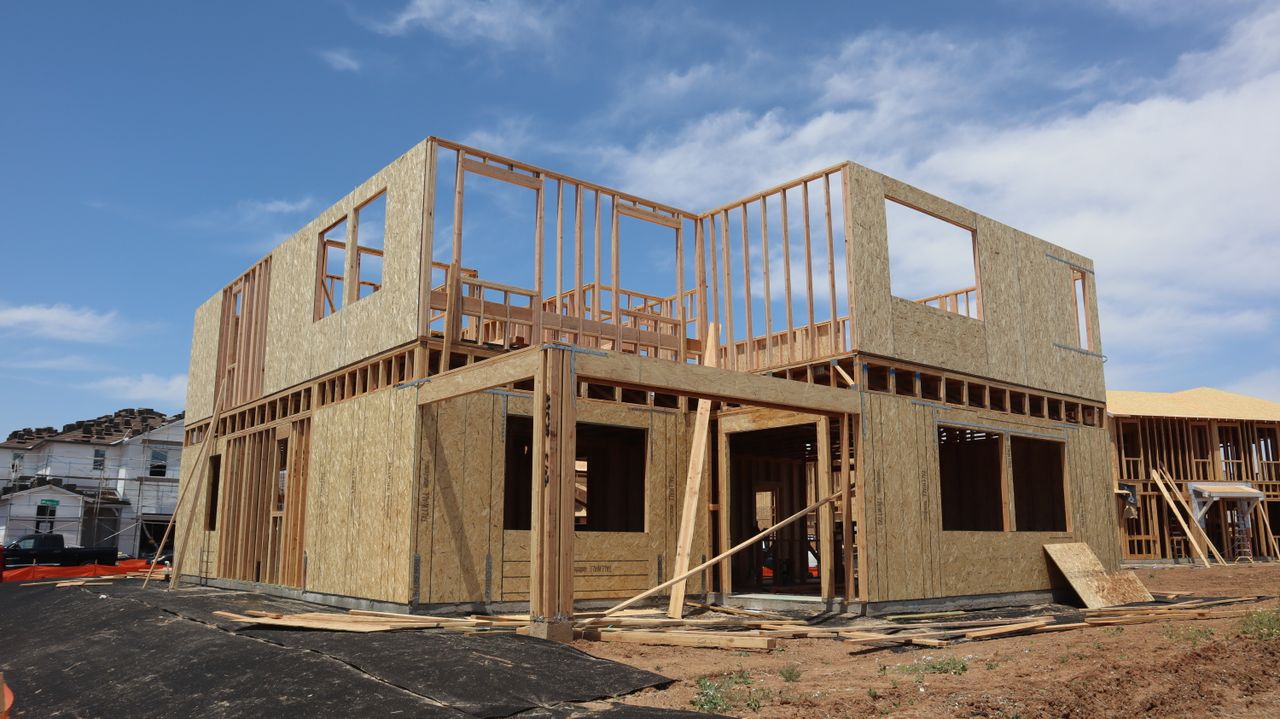 Two-story wooden house frame under construction